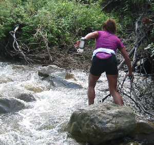 Laura DeWald crosses stream one of many times